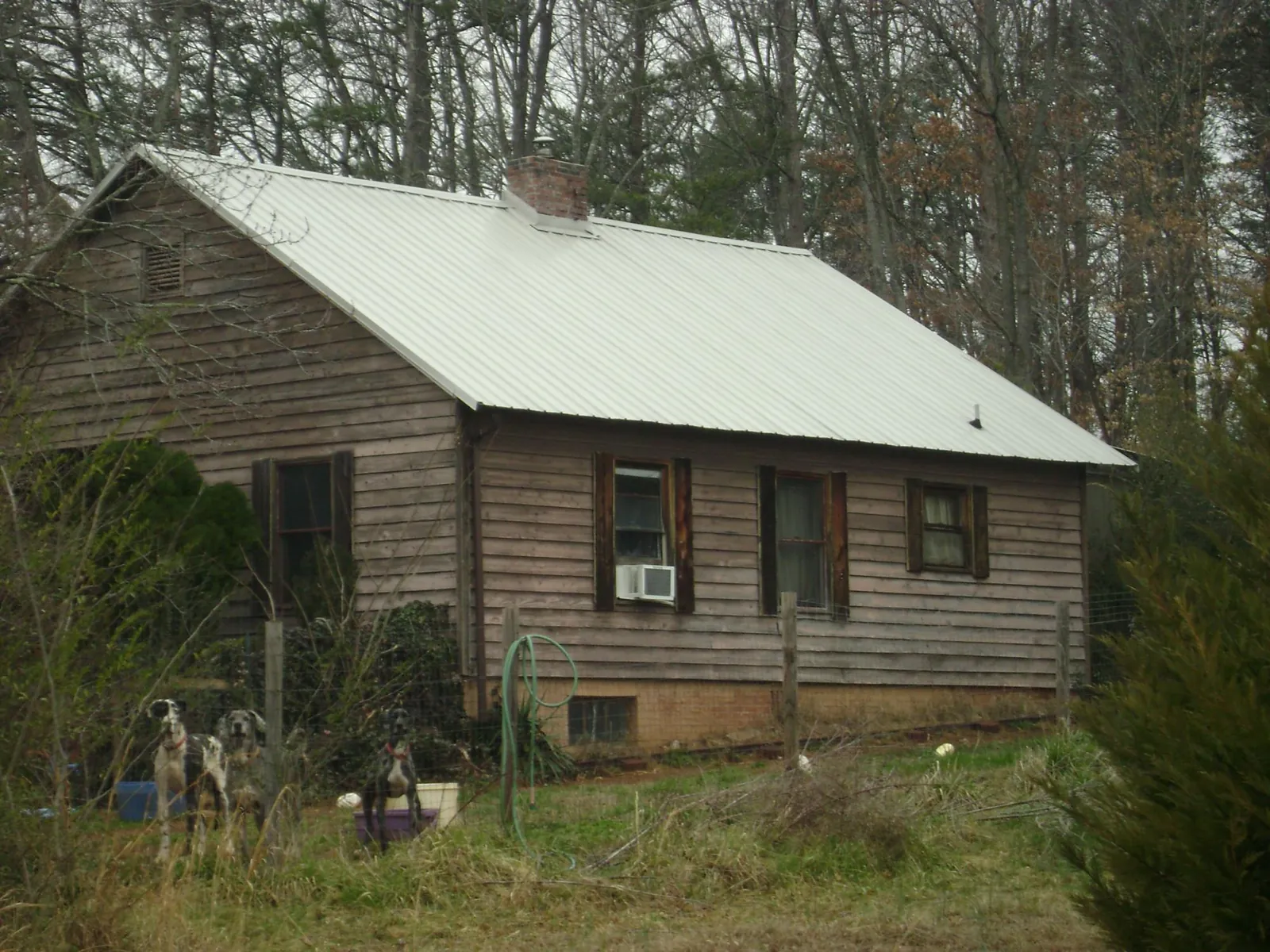 White metal roof on an old wood sided farmhouse, from a Metal Roof Installation job in Wadesville